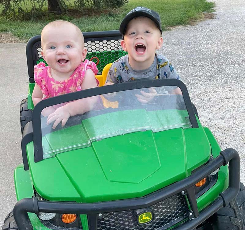 Grandkids in electric John Deere truck